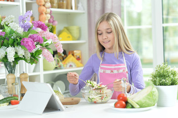 Portrait of cute girl preparing fresh salad