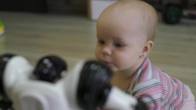 The little girl carefully looks at the toy robot and dances with him. Modern Robotic Technologies