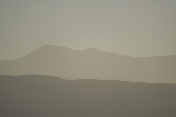 Mountain layers of the andean precordillera pre-mountain range and the cordillera at sunset, San...