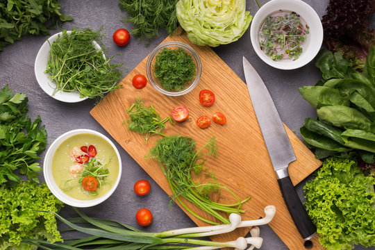 Cream soup with tomato and microgreens on kitchen table