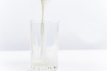 a glass of milk with bread and grains