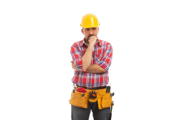 Builder touching chin as planning.