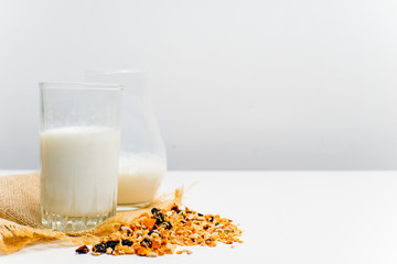 a glass of milk with bread and grains