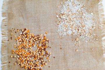 different types of groats in pots on a white background