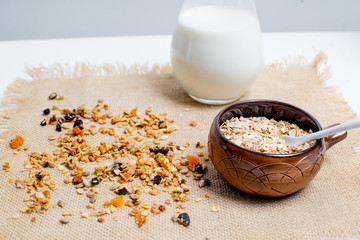 different types of groats in pots on a white background
