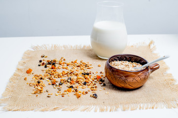 different types of groats in pots on a white background