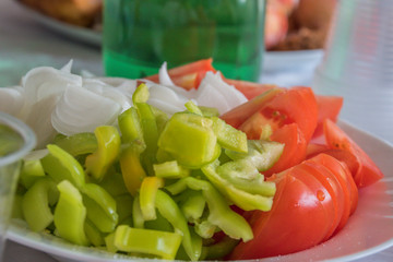 Tomatoes and paprika with onions salad closeup.