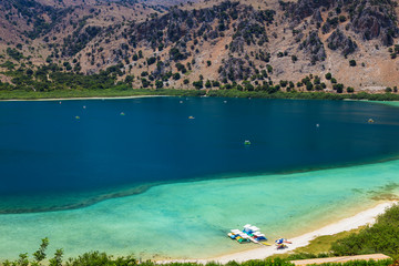 Pedal catamarans at the coast of lake Kournas at Crete island. Greece