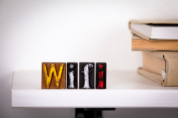 wifi word Wooden letters on the office desk, informative and communication background