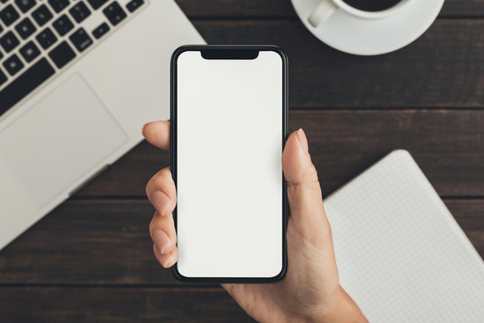 Hand holding smartphone with big blank screen