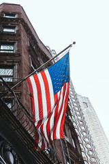 close up view of national flag and buildings in new york, usa