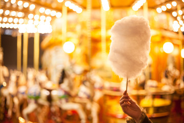 A cotton candy in front of an ancient German Horse Carousel built in 1896 in Navona Square, Rome,...