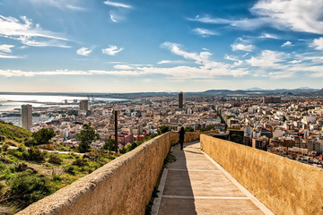 View of ramp connecting Santa Barbara castle with downtown Alicante; high angle view of the city and the Mediterranean sea.