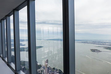 view on cloudy sky and new york city through window, usa