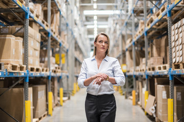 Woman in factory storehouse looking around
