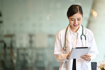 Portrait of a Asian doctor using a digital tablet in a hospital