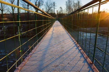Suspension bridge in the autumn morning