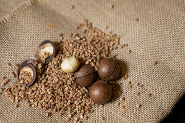 Macadamia nut on burlap with buckwheat.
