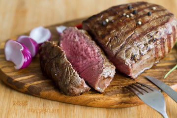 Food. Steak filet mignon, decorated chili and onions