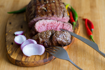 Food. Steak filet mignon, decorated chili and onions