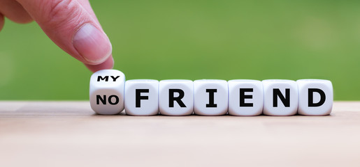 Hand is turning a dice and changes the expression "no friend" to "my friend"