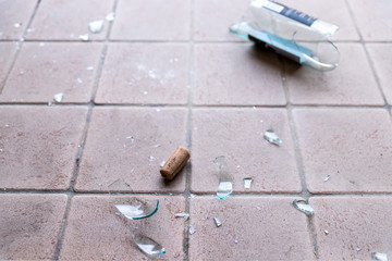 Broken glass on the floor, alcohol abuse