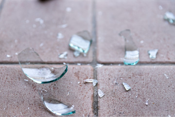 Broken glass on the floor, alcohol abuse