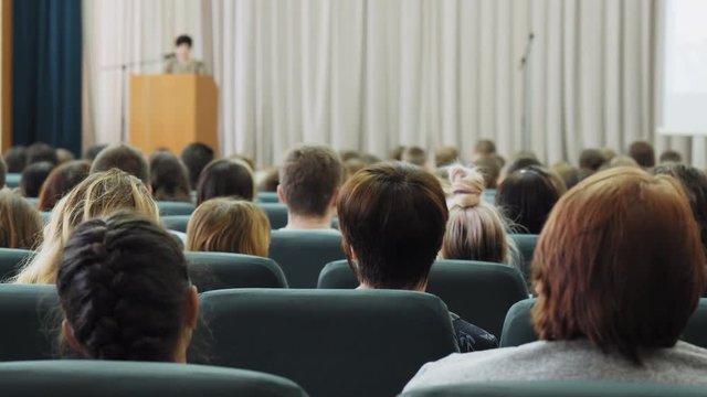 Woman speaks to an audience