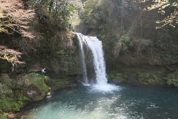 Fototapeta na wymiar People who enjoy fishing near the waterfall