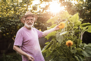 Happy old man is in the garden and smiling