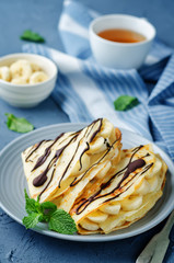 Crepes with fresh banana slaces and dark chocolate