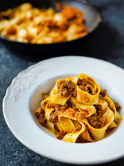 rustic italian pappardelle bolognese pasta in meat sauce