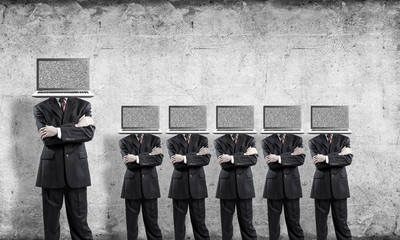 Businessmen with laptops instead of head.