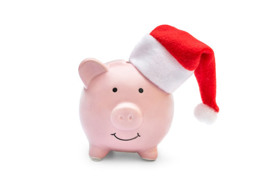 Piggy bank with santa's hat on white.