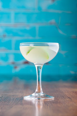 Traditional classic cocktail daiquiri, image for the menu. decorated with lime at bar background. Space for text
