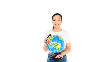 cheerful young woman holding globe isolated on white