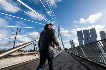 man walking on Erasmus Bridge