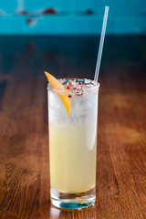 yellow cocktail on bar background, night club scenery