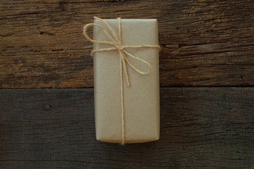 Simple eco friendly gift boxes package wrap with brown paper in old wooden table background, green present concept
