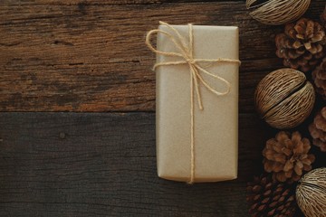 Simple eco friendly gift boxes package wrap with brown paper in old wooden table background, green...