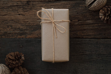 Simple eco friendly gift boxes package wrap with brown paper in old wooden table background, green present concept