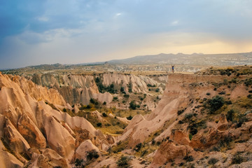 Tourist woman enjoy sunset mountain view in Cappadocia