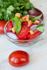 Healthy cooking of salad with fresh delicious ingredients making on cutting board. Diet or vegetarian food concept.
