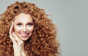 Fototapeta premium Happy redhead womanwith long curly hair. Emotion. Expressive facial expressions