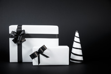 White Christmas tree and Gift box for special day isolated on black background.