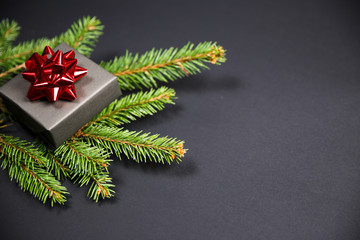 Christmas tree and gifts on gray background.