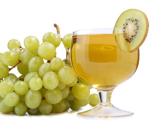 Glass of wine and green grapes on white background