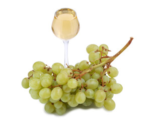 Glass of wine and green grapes on white background