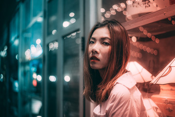 Portrait of young asian women in night city lights.