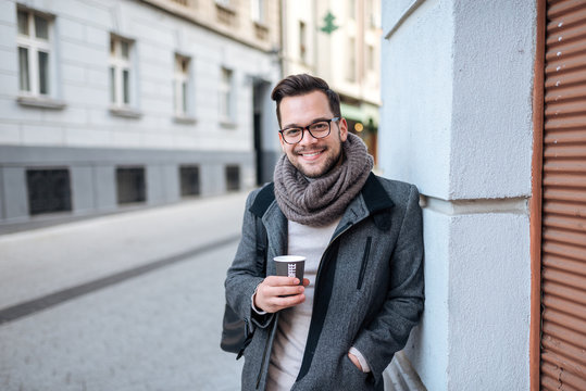 Portrait Of A Stylish Man With A Cup Of Coffee In City Street.